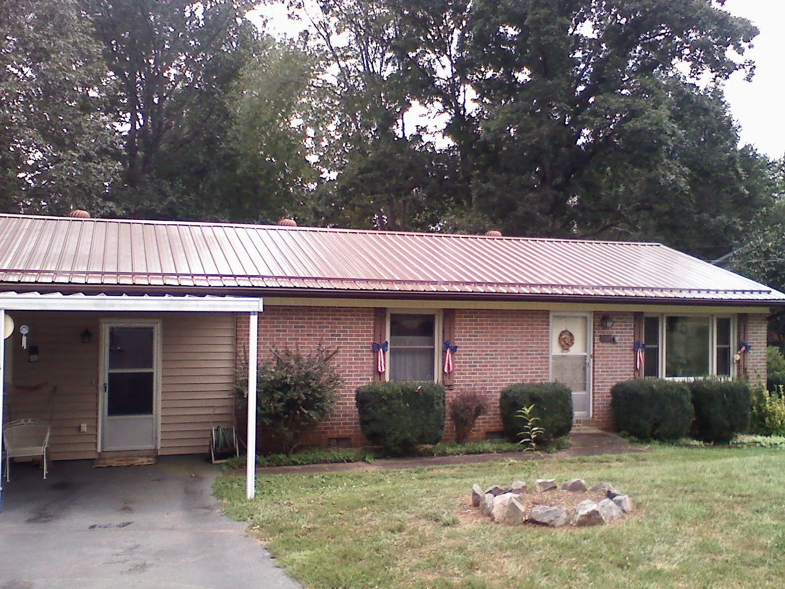 Bronze metal roof and carport on a brick ranch home — Roof Repair work by our crew in Camilla