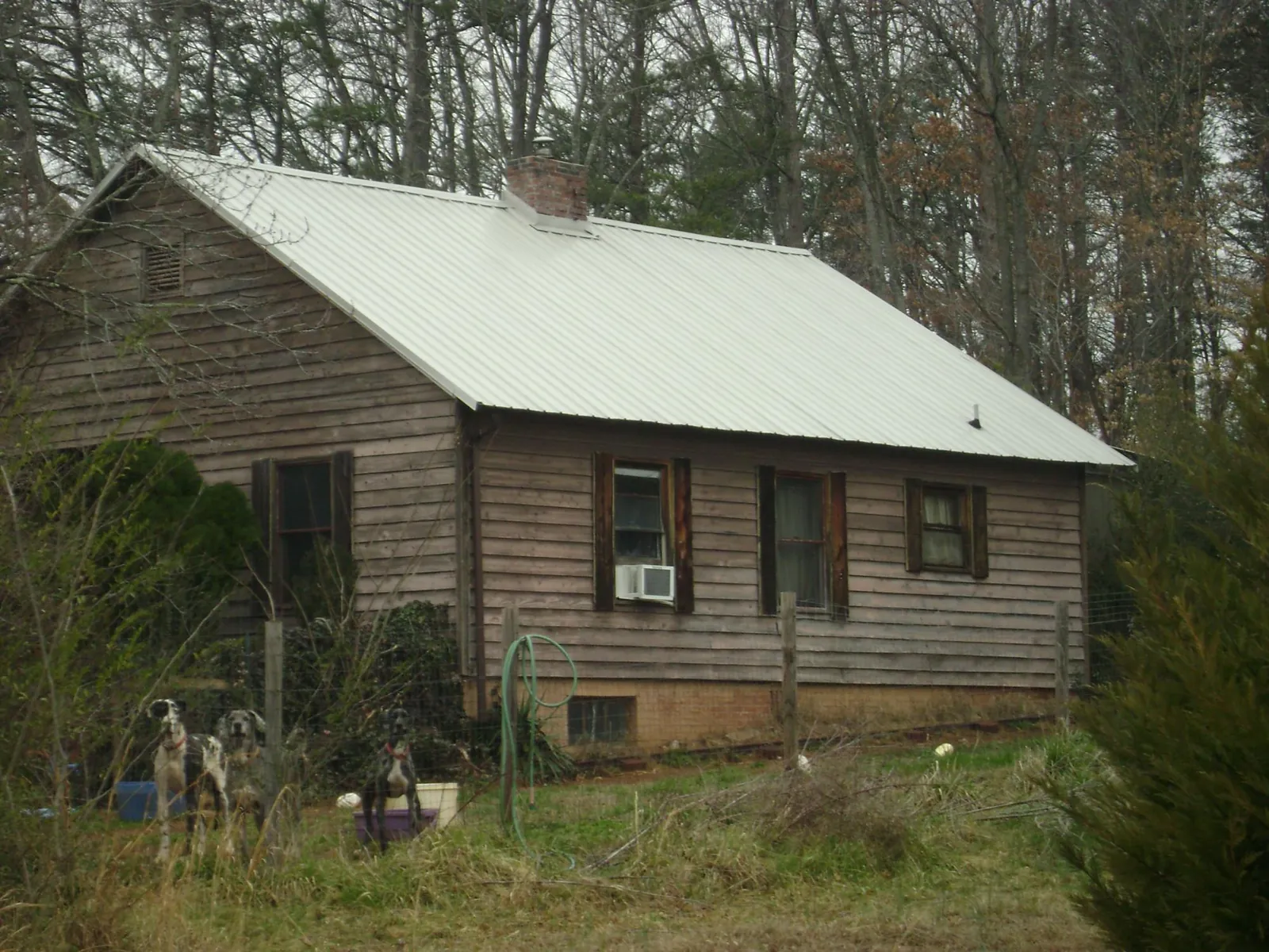 White metal roof on an old wood sided farmhouse, from a Metal Roof Installation job in Camilla